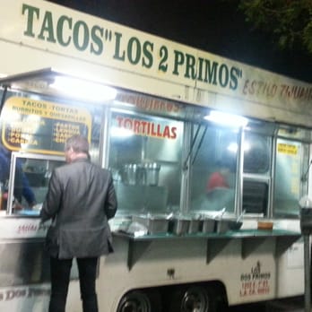 Tacos "Los 2 Primos" - a man ordering food from a food truck - Food Trucks Near Me Tacos "Los 2 Primos" - a man ordering food from a food truck - Food Trucks Near Me