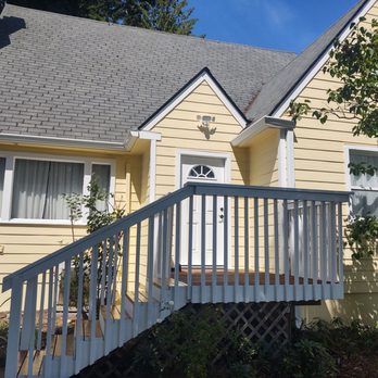 ESG Construction - Beautiful new Hardie board siding painted in a bright pretty yellow with all of the freshly painted trim. - Siding Near Me