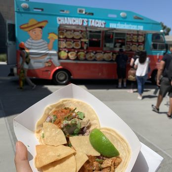 Chancho's Tacos - a hand holding a taco - Mexican Near Me - Carson, California Chancho's Tacos - a hand holding a taco - Mexican Near Me - Carson, California