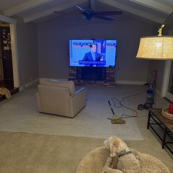 Straight Line TV Installations - Living room tv on a motorized mantle mount - Home Theatre Installation Near Me