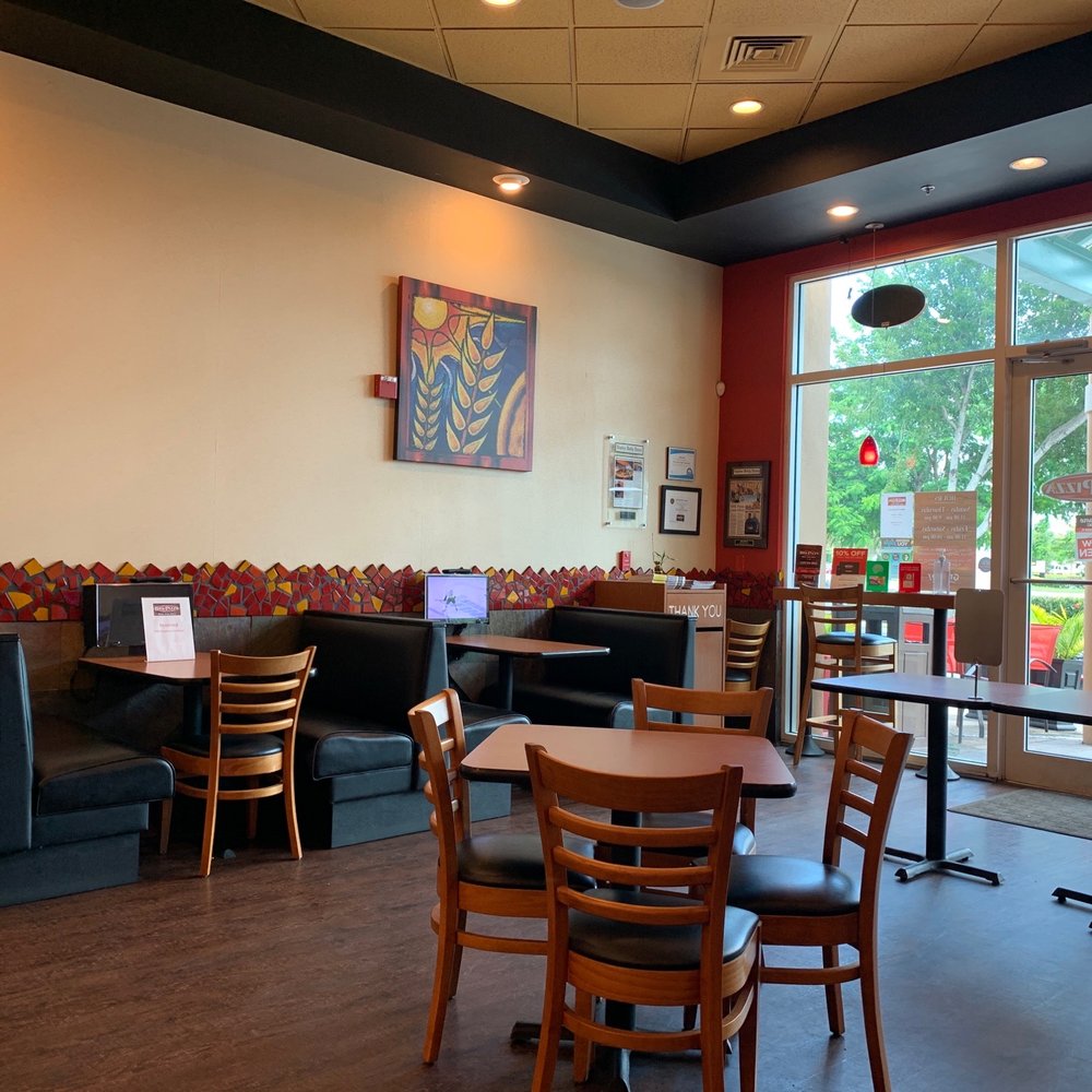 BRK Pizza - a man sitting at a table in a restaurant - Pizza Near Me - Naples, Florida BRK Pizza - a man sitting at a table in a restaurant - Pizza Near Me - Naples, Florida