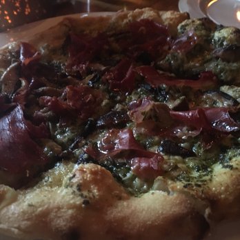 Enoteca - Strega Pizza (House made Pesto, Prosciutto, Wild Mushrooms, Asiago cheese) - Italian Near Me - Ketchum, Idaho Enoteca - Strega Pizza (House made Pesto, Prosciutto, Wild Mushrooms, Asiago cheese) - Italian Near Me - Ketchum, Idaho