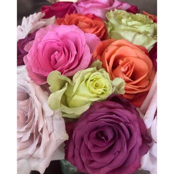 Bloom & Bee - Pretty fresh rose arrangement on each table - New American Near Me - Houston, Texas