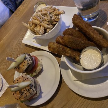 Newcastle Pub - two plates of food and a glass of water - Pubs Near Me - Calgary, Alberta Newcastle Pub - two plates of food and a glass of water - Pubs Near Me - Calgary, Alberta