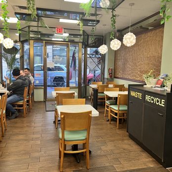 Konoz Restaurant - a man sitting at a table - Empanadas Near Me - Newark, New Jersey