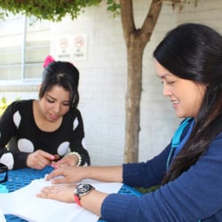 Cerritos College Cosmetology Department - Cosmetology Student, Lupe Duenas gives Anna Timbreza, a manicure at an event at Coast Plaza Hospital.