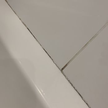 Grout Rite Restorations - Before pic. Chipped grout. - Grout Services Near Me