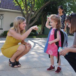 The Harbor School - Ms. Musico greets a new student on the first day of school.