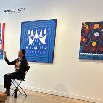 Hecho A Mano - Moira Garcia, artist, with some of her paintings - Art Galleries Near Me - Santa Fe, New Mexico