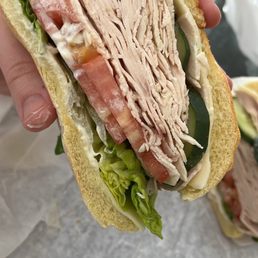 a person holding a sandwich a person holding a sandwich