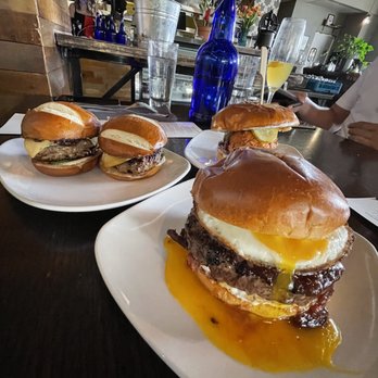 Merchant - Lamb sliders (left), Brunch burger (front), and Nashville hot chicken sandwich (back right) - Cocktail Bars Near Me - Madison, Wisconsin
