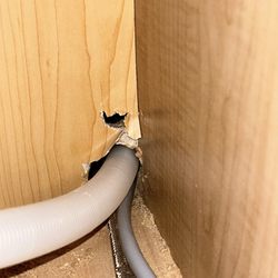 Veteran Plumbing Services - The "hole" their employee drilled in a new kitchen cabinet.
