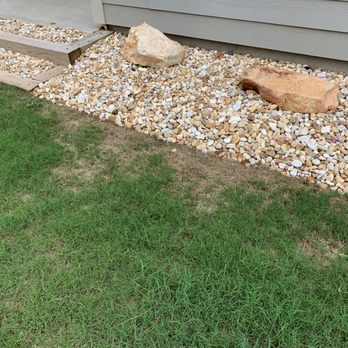R Grassing Company - a lawn with rocks and grass - Lawn Services Near Me R Grassing Company - a lawn with rocks and grass - Lawn Services Near Me