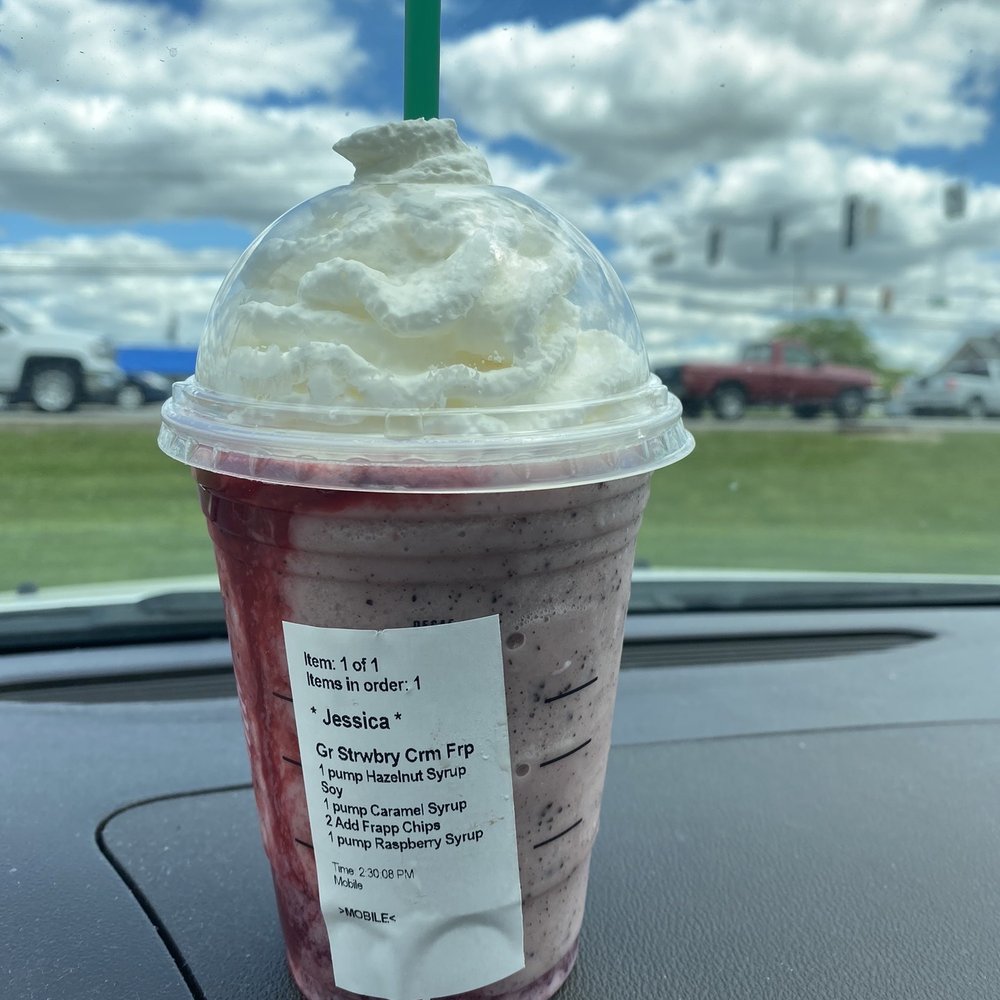 a drink in a plastic cup on the dashboard of a car a drink in a plastic cup on the dashboard of a car