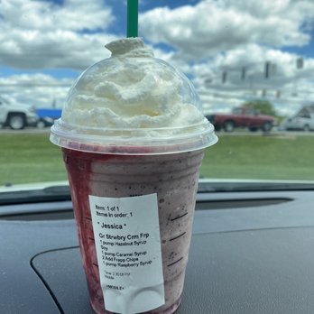 Starbucks - a drink in a plastic cup on the dashboard of a car - Coffee & Tea Near Me - Anderson, Indiana