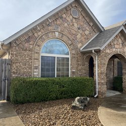 Bed Revival Landscaping - Trimmed plants and chocolate river rock