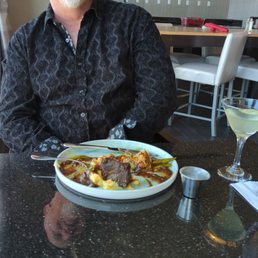 a man sitting at a table with a plate of food