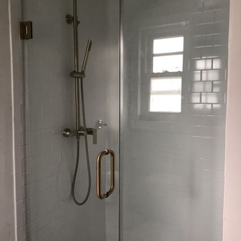 Premium Construction Services - New shower with tile, glass door, and brass showerhead - General Contractors Near Me - Dumfries, Virginia