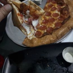 Four cheese pizza slice with pepperoni