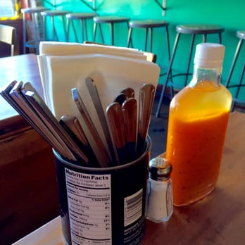 Parada 22 - The table setup is humble but that Puerto Rican hot sauce is delightful, tasty, vinegary, loaded with flavor and not too hot. - Latin American Near Me - San Francisco, California