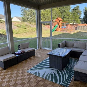 Unique Home Improvements - a covered patio with furniture - Landscaping Near Me Unique Home Improvements - a covered patio with furniture - Landscaping Near Me