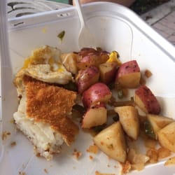Fried fish and eggs, with home fries.
