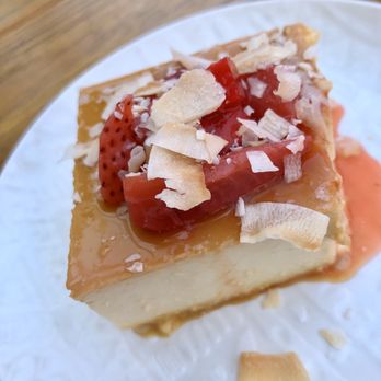 NIDO's BackYard - FLAN DE COCO - $7.00 - Coconut and Vanilla Caramel Custard, Strawberry Compote, Dried Coconut. - Mexican Near Me - Oakland, California NIDO's BackYard - FLAN DE COCO - $7.00 - Coconut and Vanilla Caramel Custard, Strawberry Compote, Dried Coconut. - Mexican Near Me - Oakland, California
