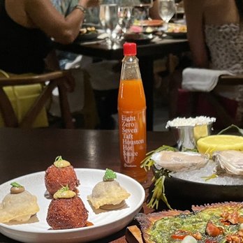 Bludorn - Baked oysters, tarte flambé, and their in houses hot sauce. - New American Near Me - Houston, Texas