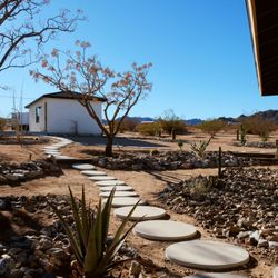 Landers Sorensen Design - Front yard remodel. Stones, small retaining wall, French drain, stepping stones, drip irrigation and plant install.