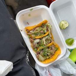 a couple of tacos in a styrofoam container a couple of tacos in a styrofoam container