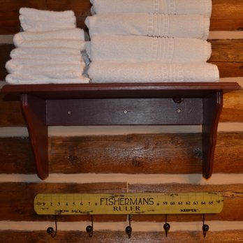 Lure Me Inn - Fishing humor under the towel shelf in the bathroom. - Hotels Near Me - Ennis, Montana Lure Me Inn - Fishing humor under the towel shelf in the bathroom. - Hotels Near Me - Ennis, Montana