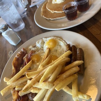 Genie G's - Hungry Man Meal: 3 eggs, 3 sausage links, 3 bacon strips with french fries and all you can eat pancakes. - New American Near Me - Phoenix, Arizona