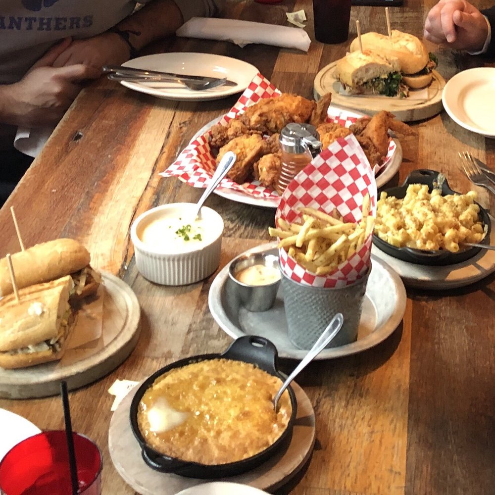 The Eagle OTR - From top to bottom: pork sandwich, whole fried chicken, mac & cheese, white cheddar grits, fries, blackened shrimp po boy, and spoonbread - American Near Me - Cincinnati, Ohio The Eagle OTR - From top to bottom: pork sandwich, whole fried chicken, mac & cheese, white cheddar grits, fries, blackened shrimp po boy, and spoonbread - American Near Me - Cincinnati, Ohio