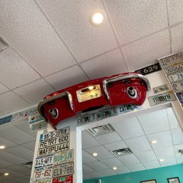 a red car on top of a mirror a red car on top of a mirror