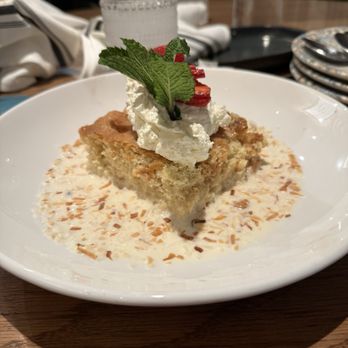 Mexican Sugar Las Colinas - Slice of Coconut & Golden Raisin Tres Leches Cake - Latin American Near Me - Irving, Texas