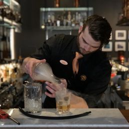 a bartender pouring a drink a bartender pouring a drink