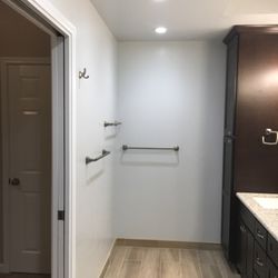 European Quality Construction and Remodeling - Hardwood looking tile floor and bathroom accessories