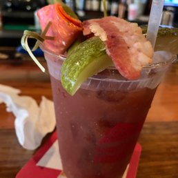 a bloody drink with bacon and pickles