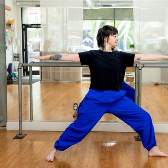 Logan Square Pilates Core - Our yoga instructor mid -warrior stance - Pilates Near Me - Chicago, Illinois Logan Square Pilates Core - Our yoga instructor mid -warrior stance - Pilates Near Me - Chicago, Illinois