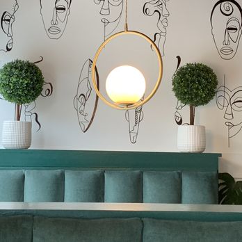 Breakfast At Barneys - Lighting, wall art and plants above a booth at Barneys - Breakfast & Brunch Near Me - Atlanta, Georgia