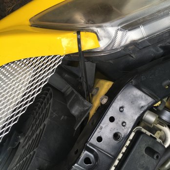 Flagstaff Auto Exchange - Wire tie to hold front bumper cover on and missing radiator bracket, again top mount of bumper cut, appears to been wreaked in their care - Used Car Dealers Near Me - Flagstaff, Arizona