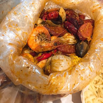 Cap't Loui - 3 lbs. of seafood (head-on shrimp, clams, and crawfish) + sausages, corn, and potato in medium Louisiana sauce - Cajun/Creole Near Me - Duluth, Georgia