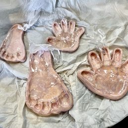 Foot and handprints from 8 days old and then 1 year old.