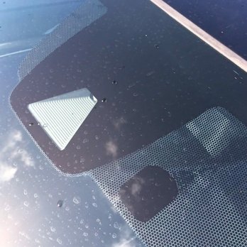 Dynamic Auto Customs SC - My car front windshield 3rd attempt.   Tint above rear view mirror lifted.  When they put it back it creased. - Car Window Tinting Near Me