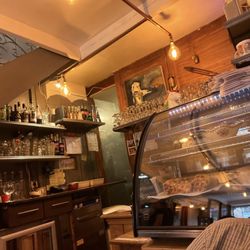 La Petite Table - Back of the restaurant near the kitchen. Dessert case and bar area.