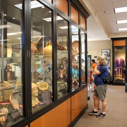 Hellenic - American Cultural Center & Museum - A visitor views a display of Ottoman era copper pieces at the museum.