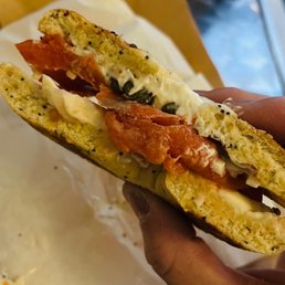 a person holding a sandwich a person holding a sandwich
