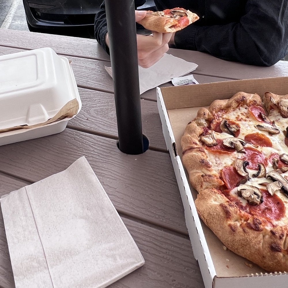 a person eating a slice of pizza