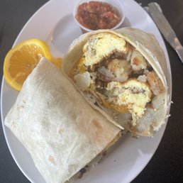 Breakfasts wrap. Very generous size. Eggs, sausage and hash browns in there. Breakfasts wrap. Very generous size. Eggs, sausage and hash browns in there.