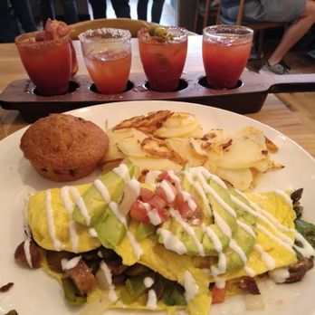 Broken Yolk Cafe - "Mom" omlette with sausage and jalapeños added. Tomatoes,onion, Spinach, mushrooms, Avocado. Country potatoes and a blueberry muffin. - Breakfast & Brunch Near Me - Henderson, Nevada
